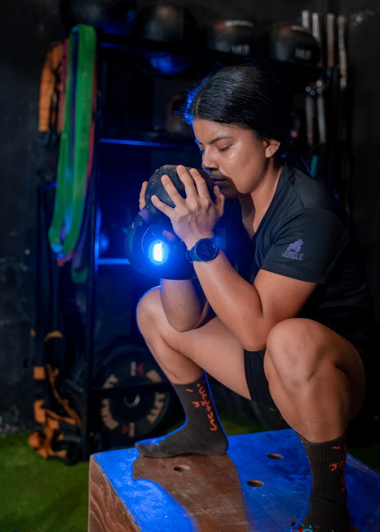 Sporty Woman Training With Dumbbell In Gym