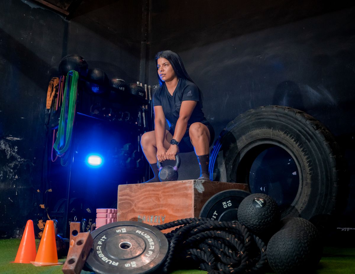 Athlete performing functional fitness kettlebell squat for HYROX training