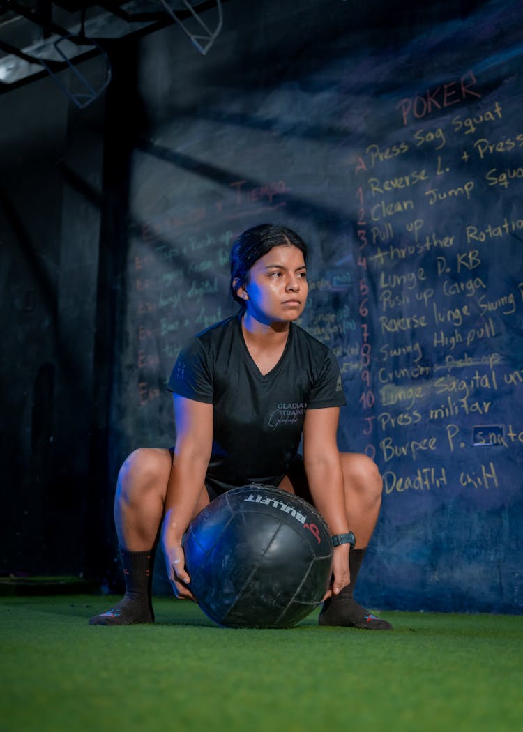 Sporty Woman Training With Ball In Gym