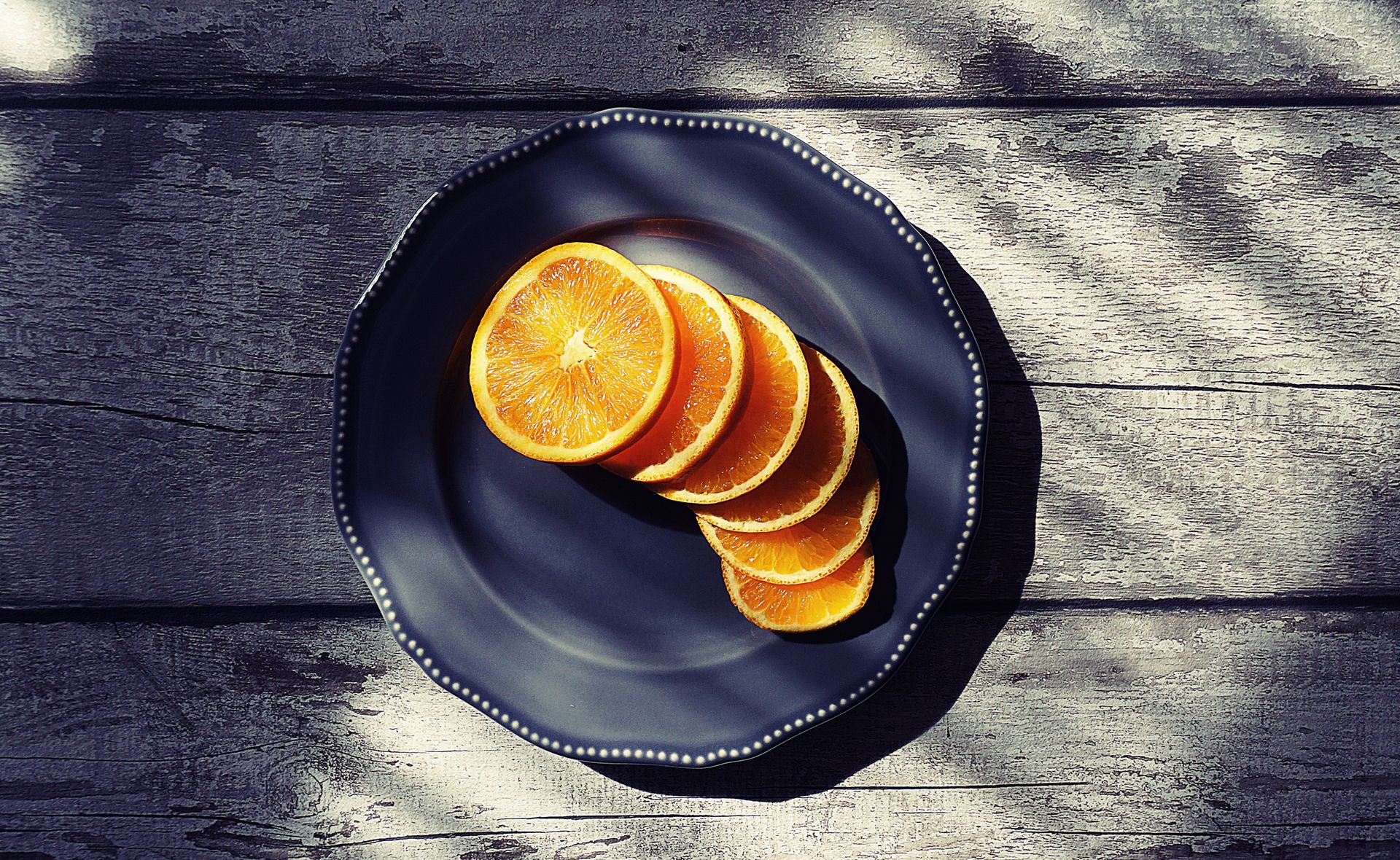 Sliced of Orange Fruits on Black Plate