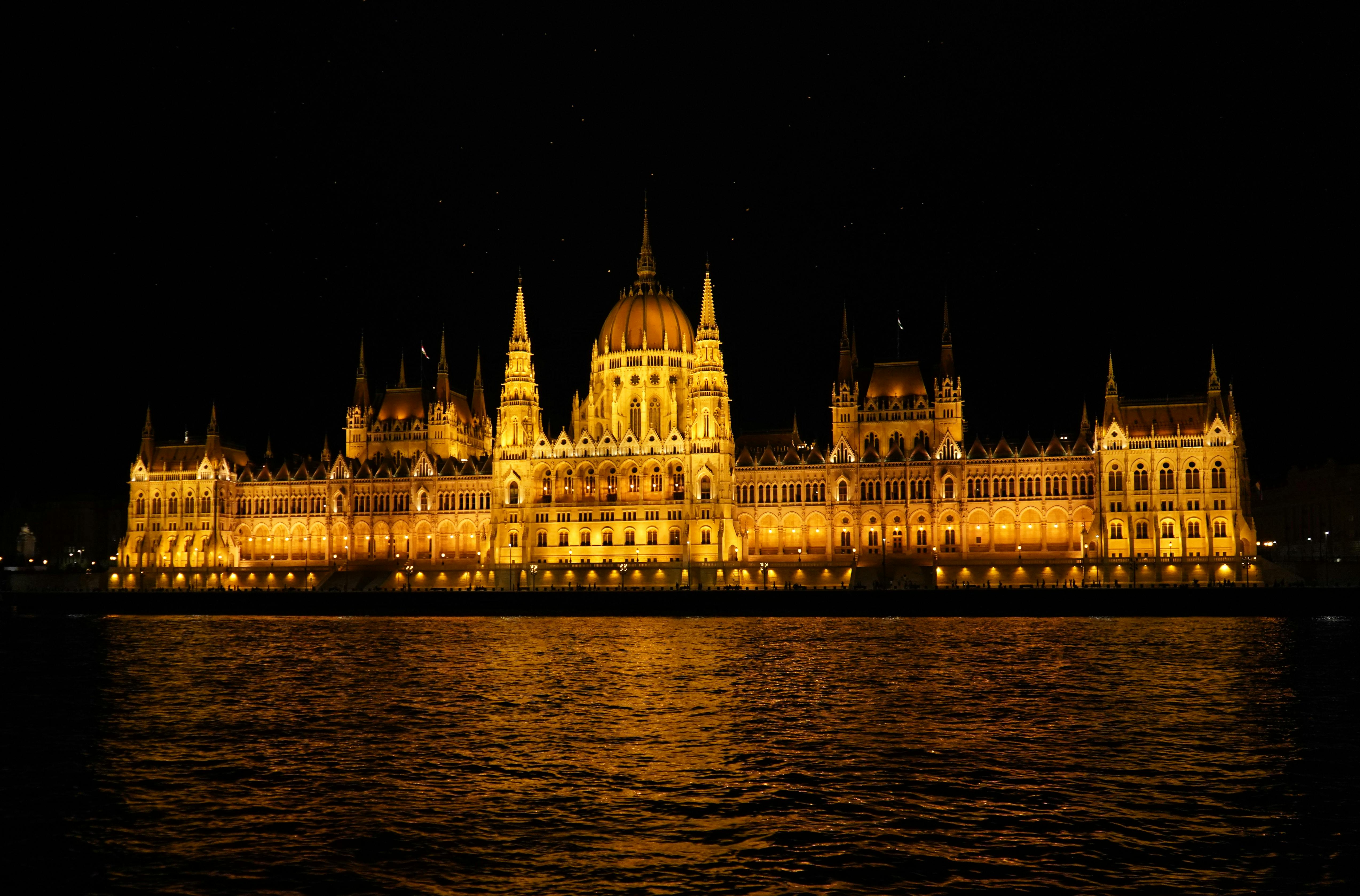 A stunning night view of the illuminated Hungarian Parliament Building reflecting on the Danube River.