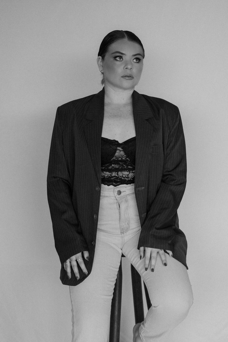 Woman in striped blazer and jeans, elegant office outfit