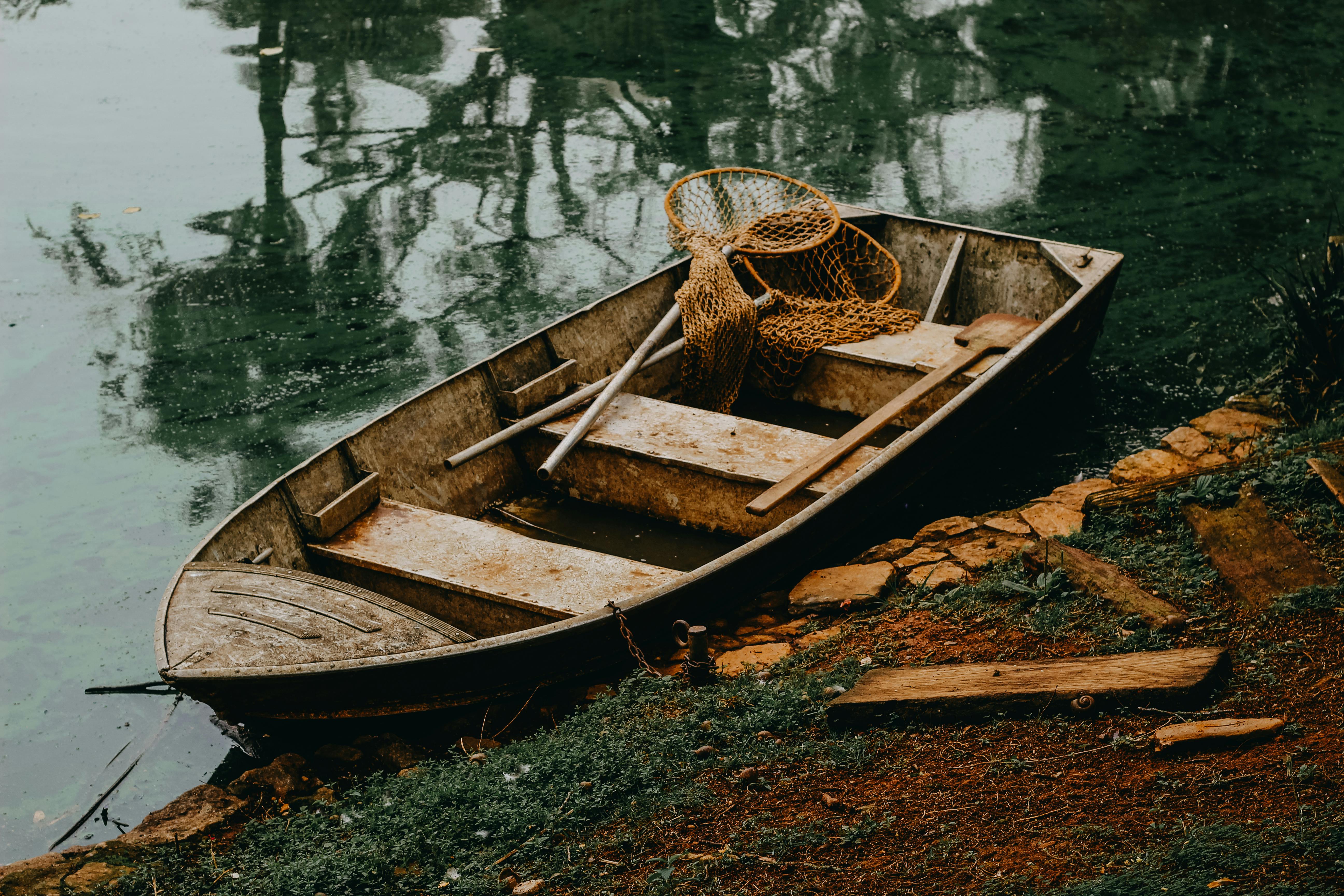 Wooden Boat with Nets on Lakeshore · Free Stock Photo