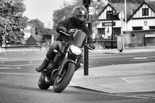 Man in Helmet Riding Motorbike on Street