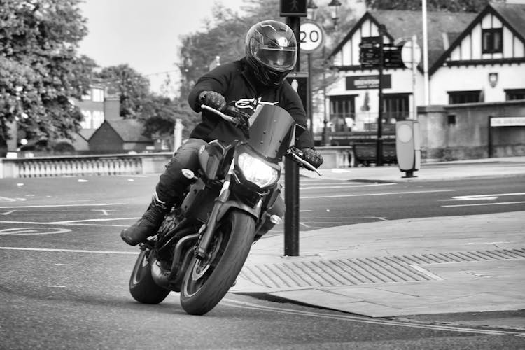 Man In Helmet Riding Motorbike On Street