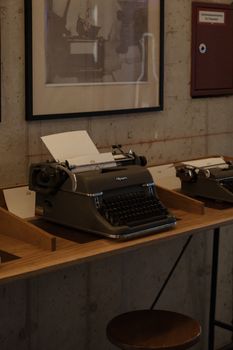 Classic typewriters showcased in a Munich museum with a retro aesthetic.