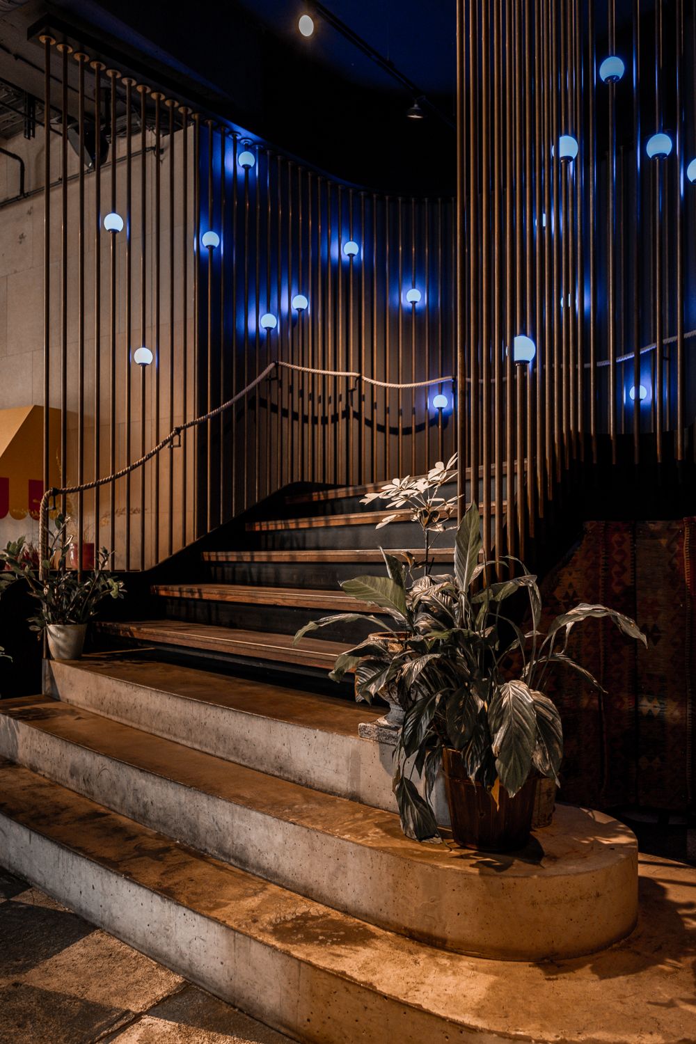 Stairs with Floor to Ceiling Railing Decorated by Blue Lamps in the ...