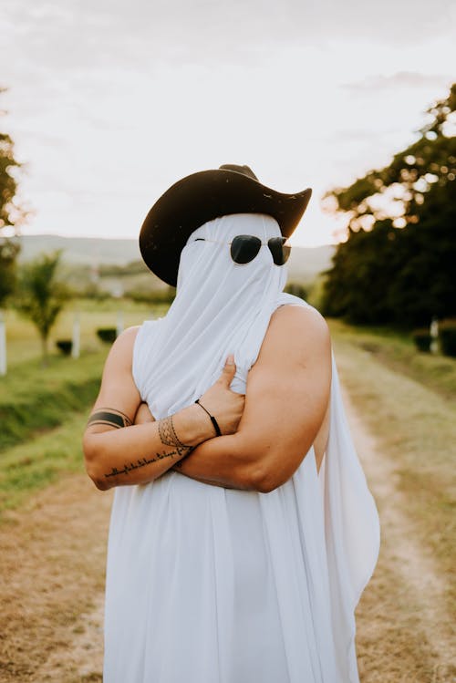 Ghost in a Cowboy Hat and Sunglasses Haunting a Dirt Road