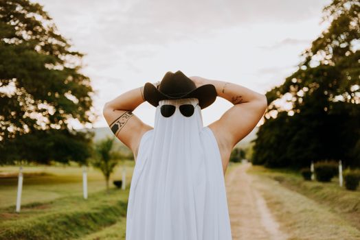 Muscled Ghost Cowboy with Tattoos on a Countryside Road