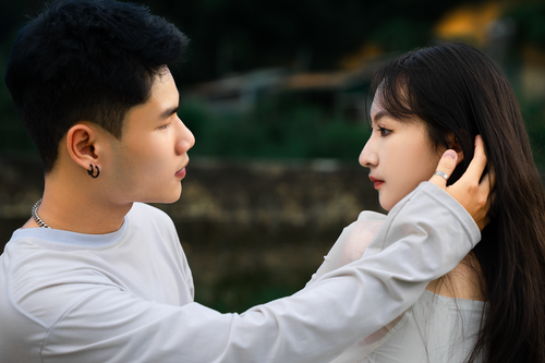 Free Young couple sharing a tender and affectionate moment outdoors in Dalat. Stock Photo