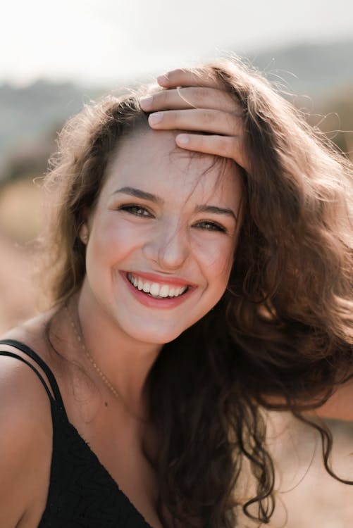 Smiling Woman Wearing Black Spaghetti-strap Top