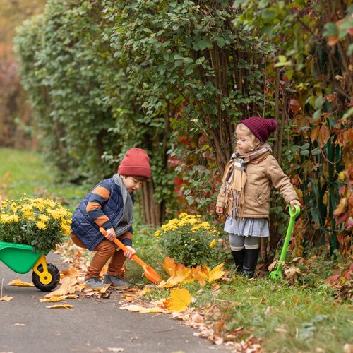Children gardening outdoors with little tools