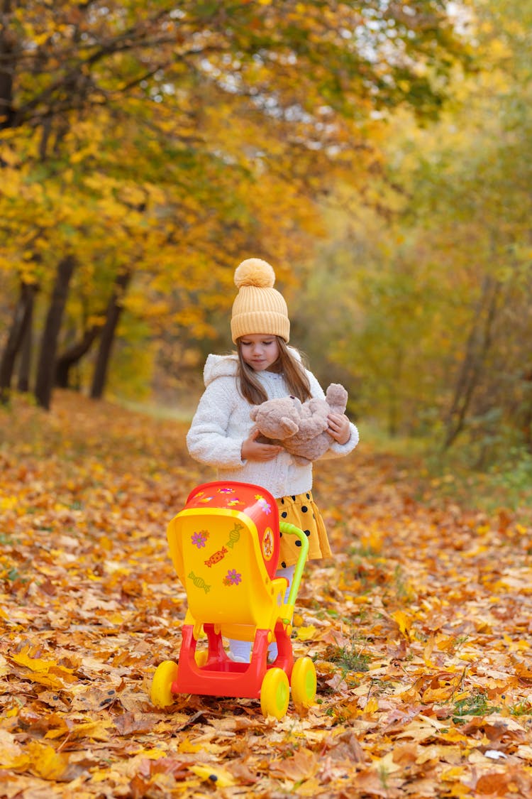 A Girl With Toys In A Forest