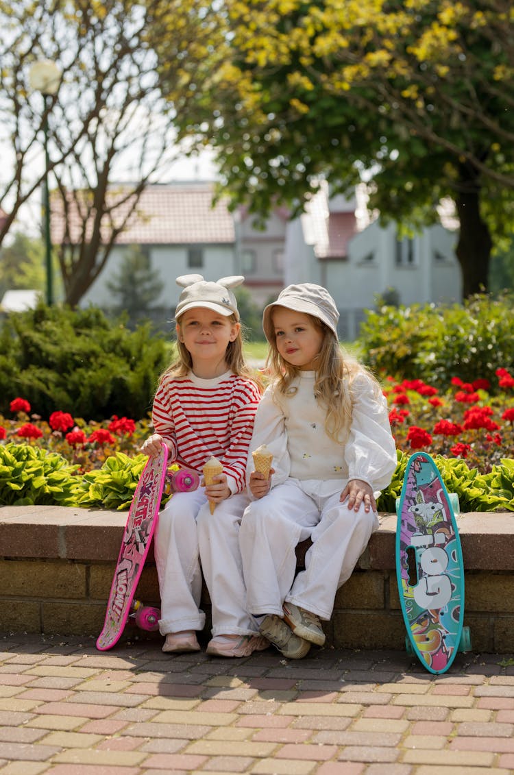 Little Girls With Long Board In A Park