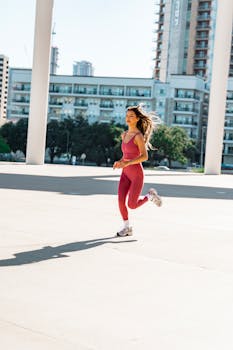 Young woman running in city area, embracing a healthy lifestyle and fitness outdoors.
