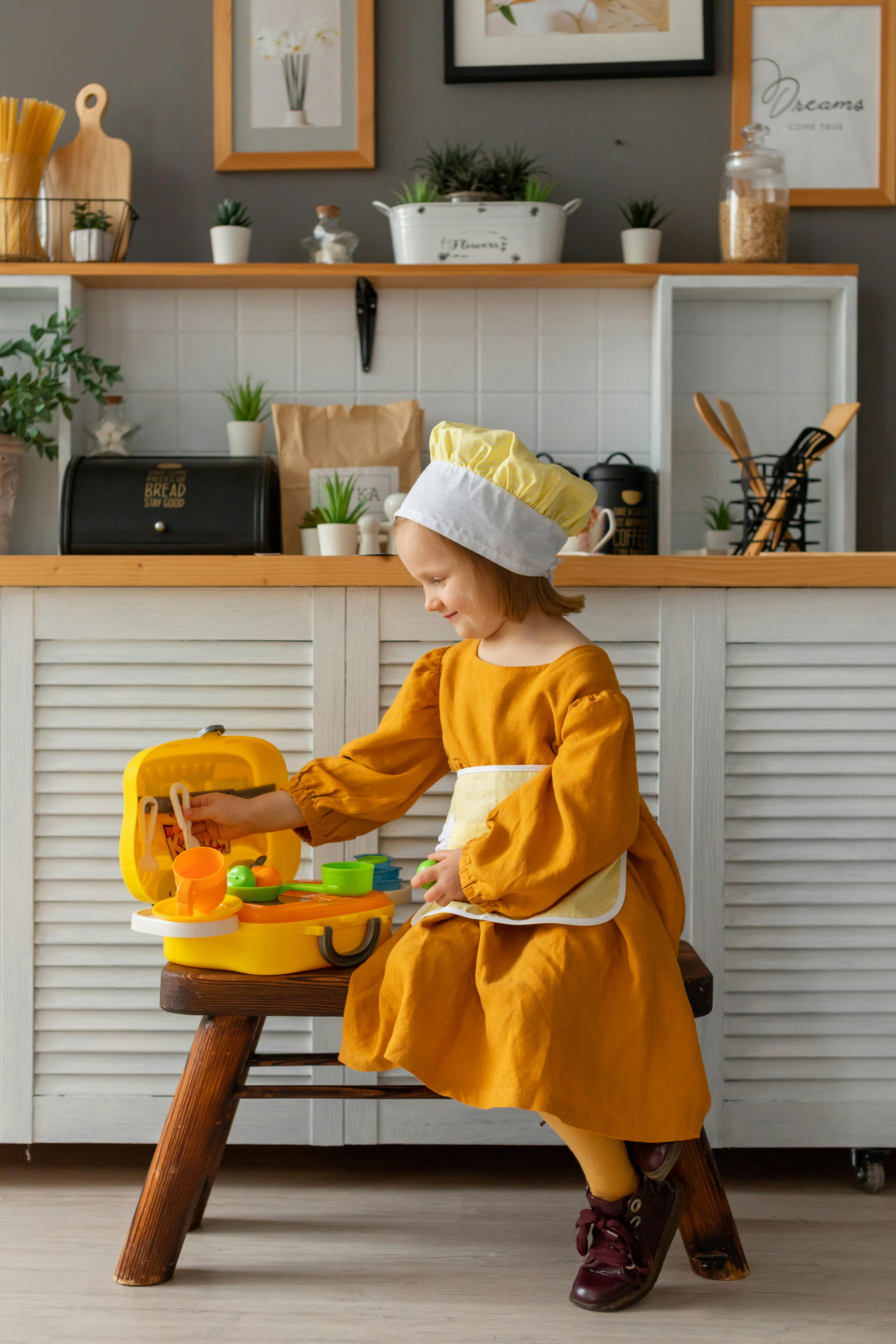 a girl playing in a kitchen