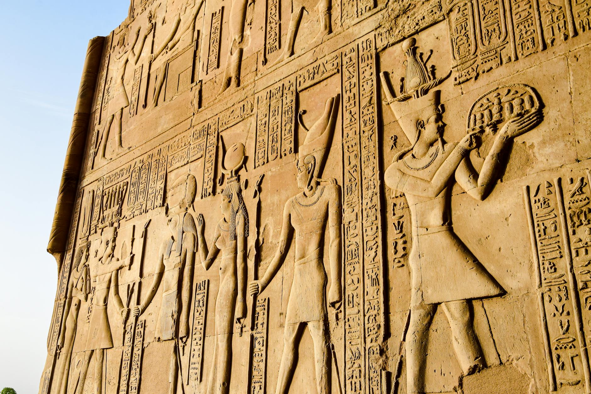 Detailed view of ancient Egyptian hieroglyphs and figures on a temple wall.