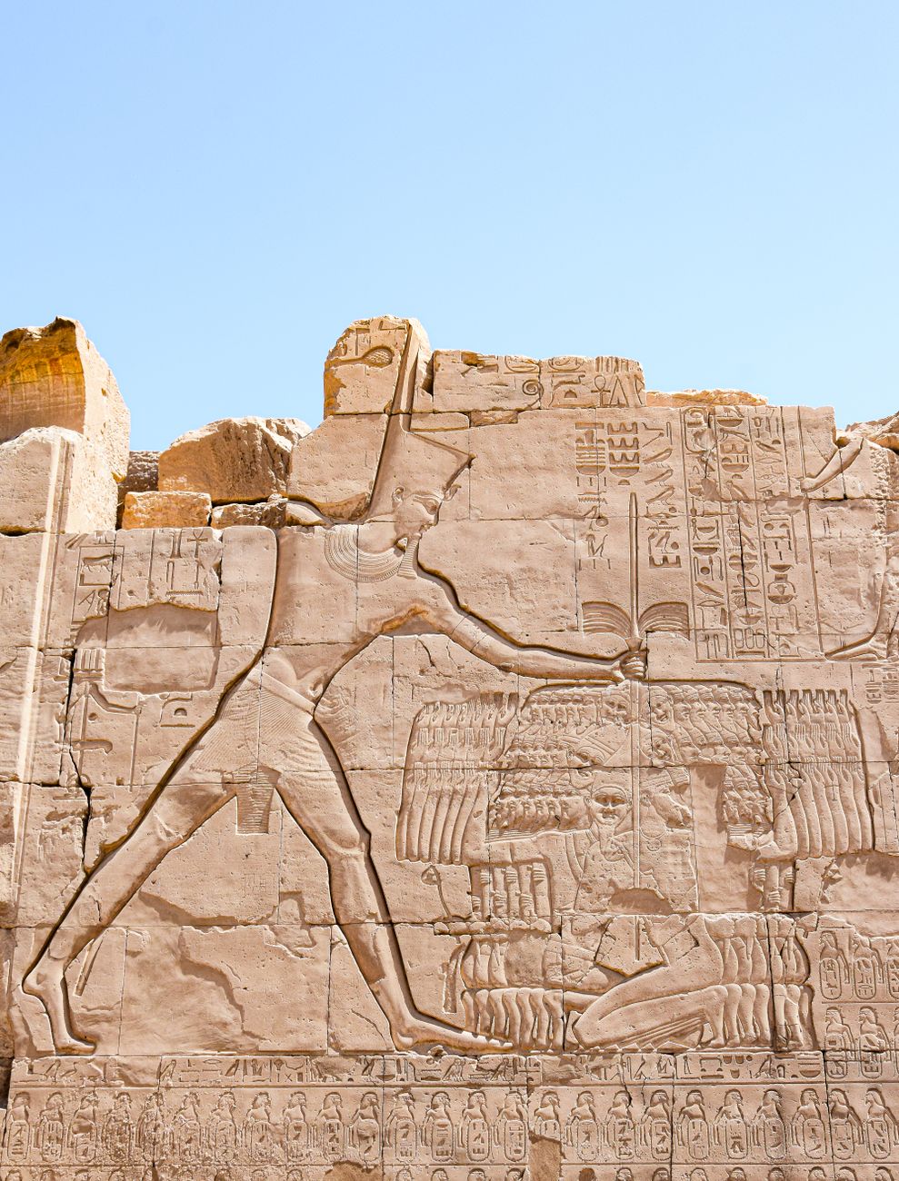 Detailed carving on an ancient Egyptian temple wall with hieroglyphs under a clear blue sky.. pexels, detailed, carving