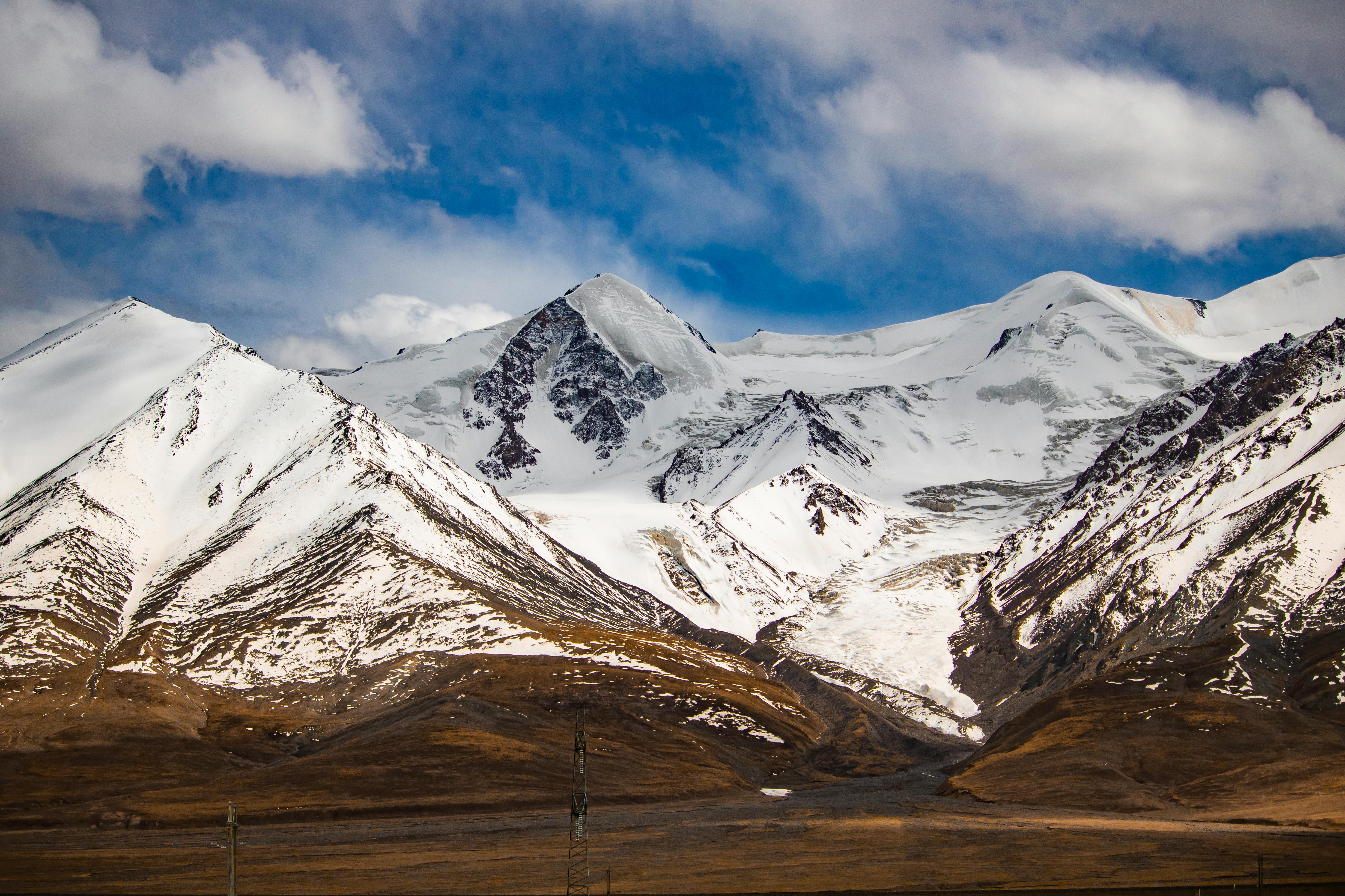 A breathtaking view of snow-capped mountains against a clear blue sky, perfect for nature lovers.