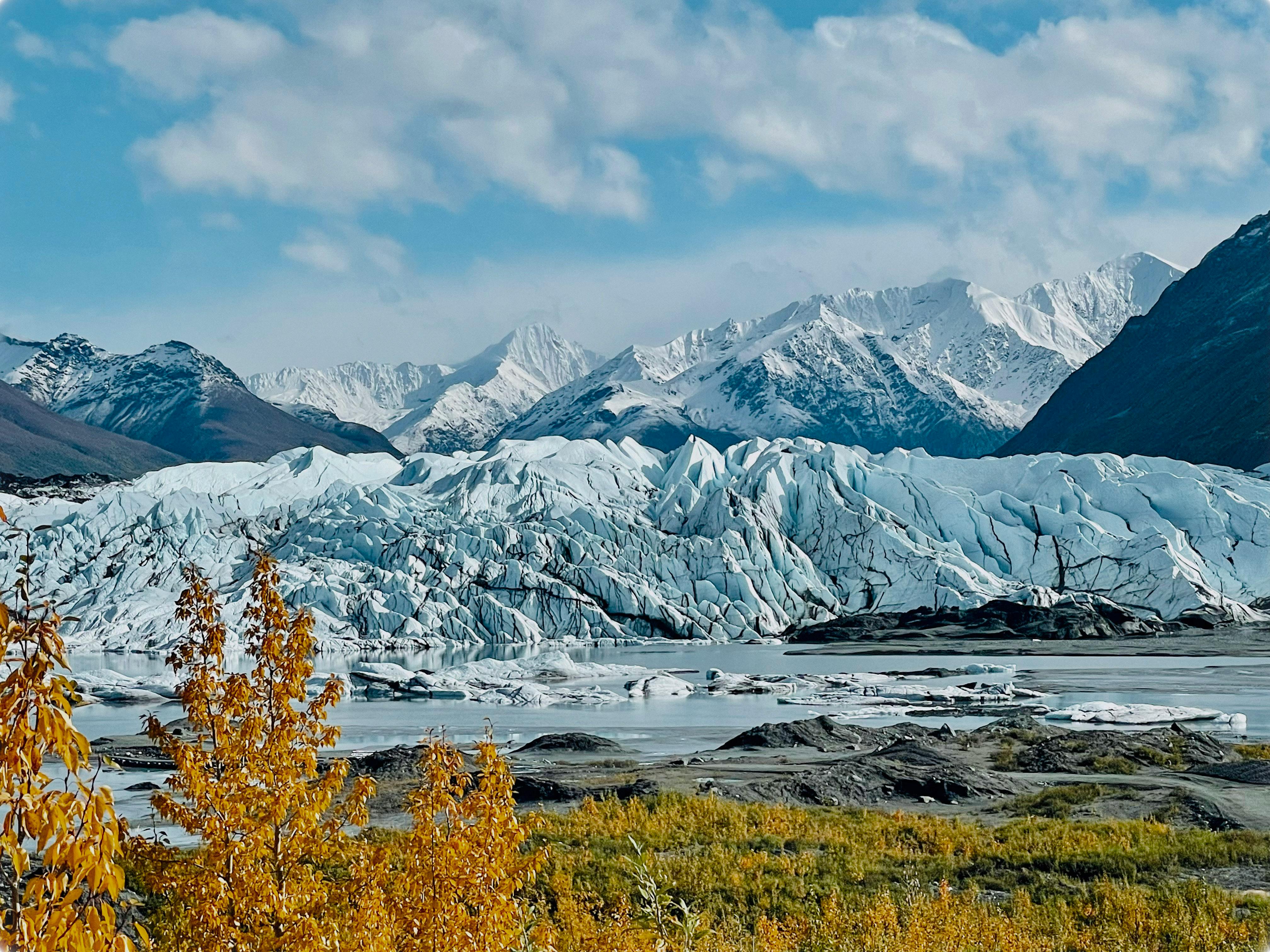 Breathtaking landscape of a glacier with autumn foliage in Alaska.