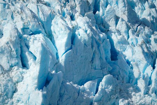Free Close-up view of a rugged, jagged blue glacier with an icy texture. Stock Photo