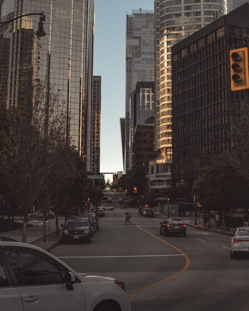 Free Beautiful downtown Vancouver street view with skyscrapers and urban elements during sunset. Stock Photo