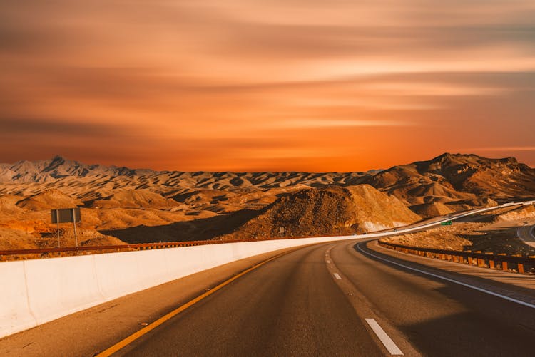 Empty Road Beside Sand Dunes