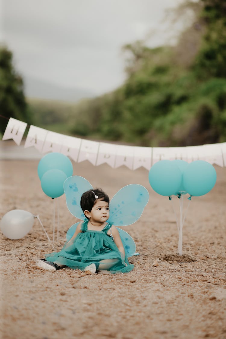 Girl In Green Dress With Butterfly Wings Sitting With Birthday Wishes Behind