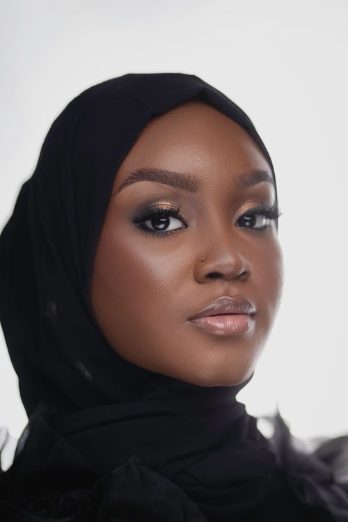 Free Close-up portrait of a beautiful woman in a black headscarf. Captured with a modern style in Nigeria. Stock Photo