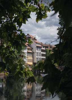 Scenic view of traditional half-timbered houses by a canal in Strasbourg, France.