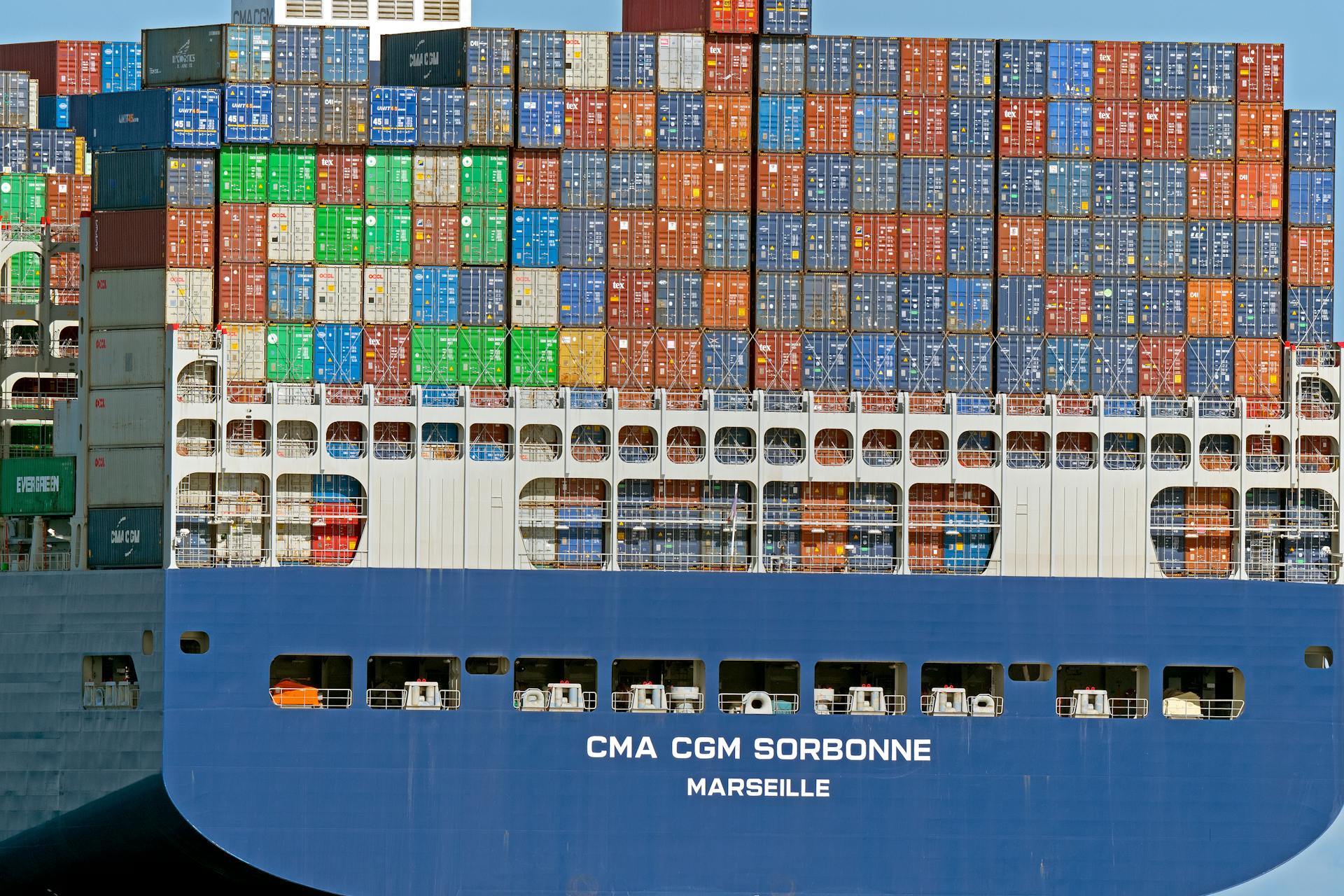 Close-up of CMA CGM Sorbonne cargo ship loaded with colorful containers in Cuxhaven, Germany.