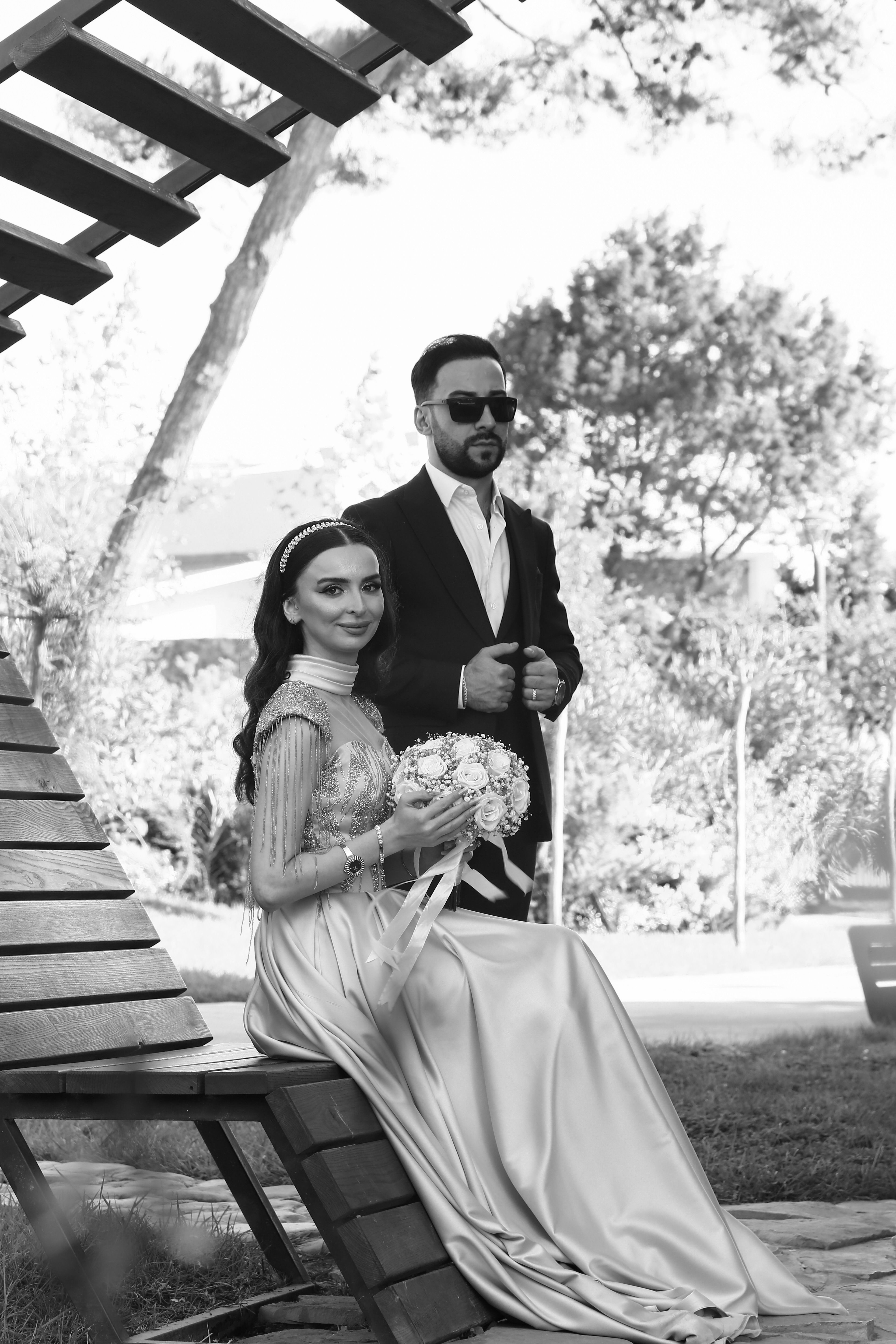 Newlyweds Sitting and Standing in Black and White · Free Stock Photo