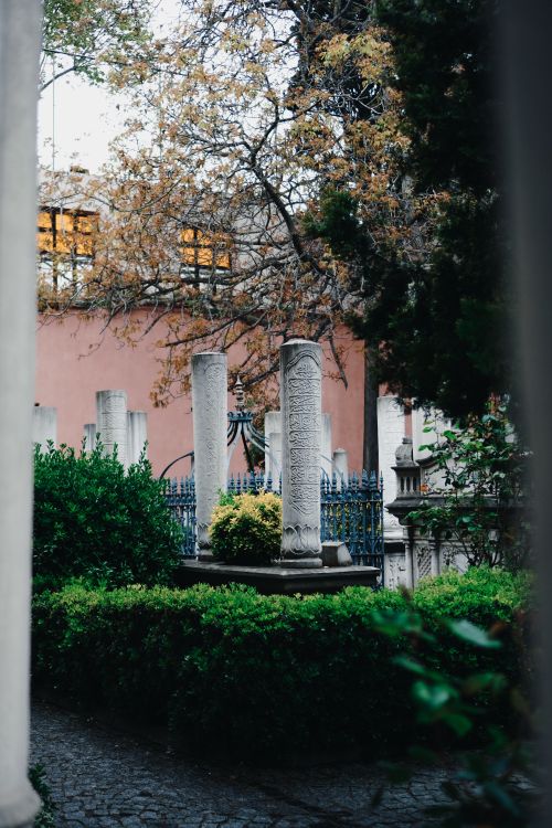 Free A serene view of an Ottoman-era courtyard with ancient columns and lush greenery in Istanbul. Stock Photo