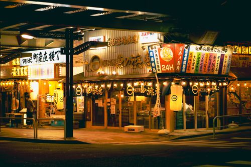 Free Vibrant Tokyo street market illuminated at night with traditional Japanese shopfronts. Stock Photo