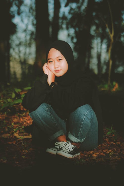 Woman in Hijab Sitting in Forest