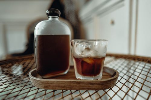 Free Glass of cold brew coffee with ice cubes on a rustic tray indoors. Stock Photo