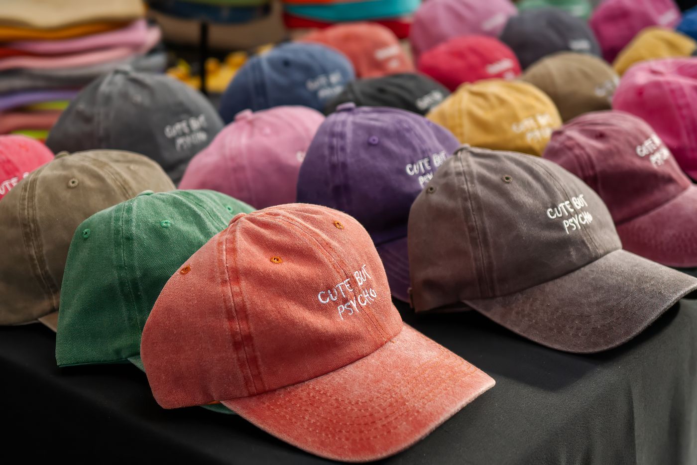 Row of embroidered baseball caps on display