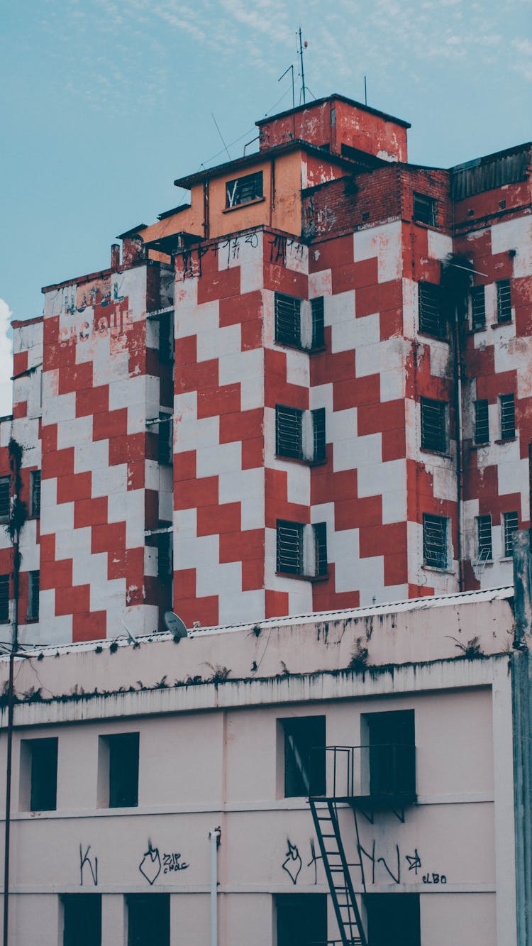 Neglected Building With White And Red Zigzags