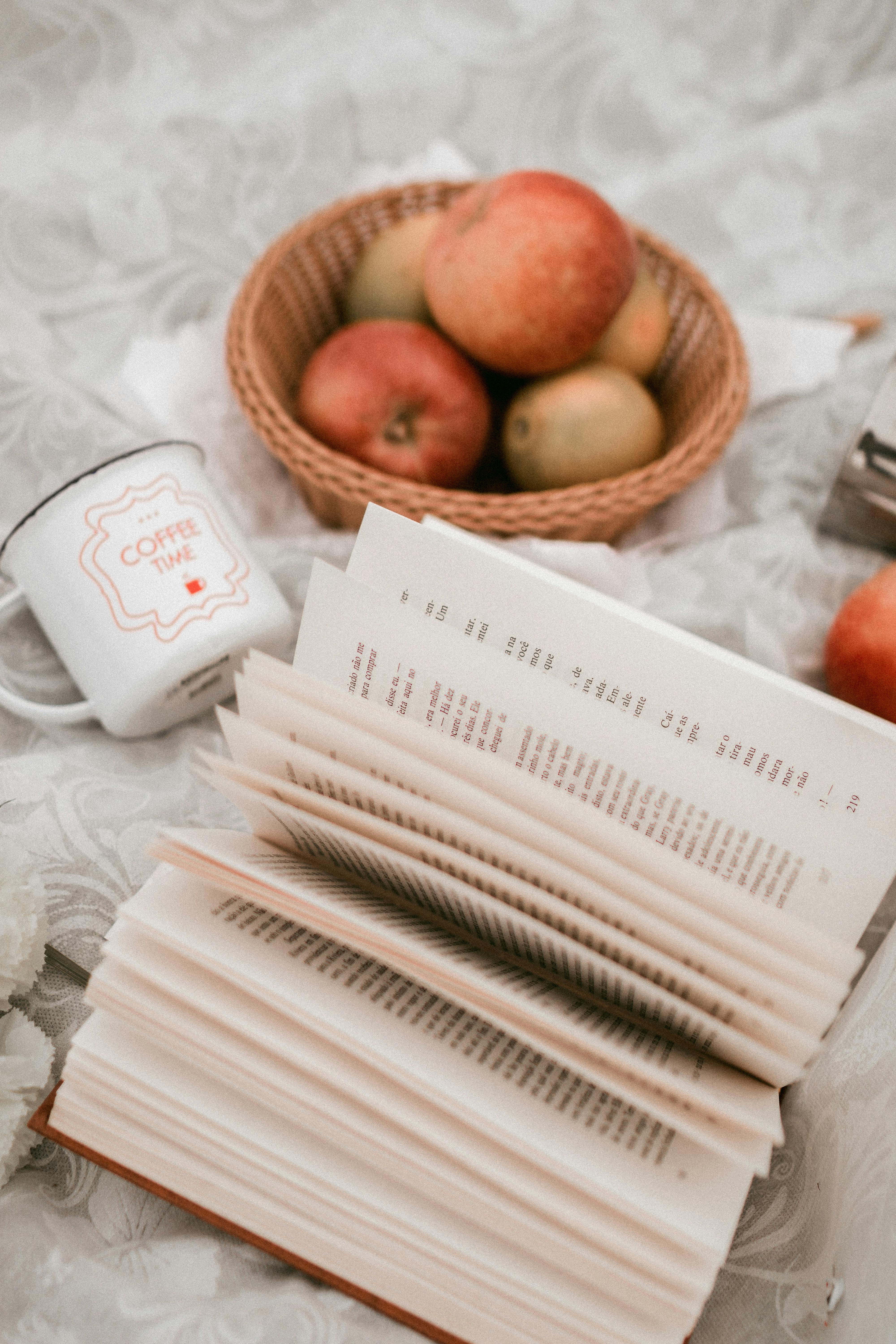 A serene autumn setting with apples, a book, and a mug, perfect for relaxation.