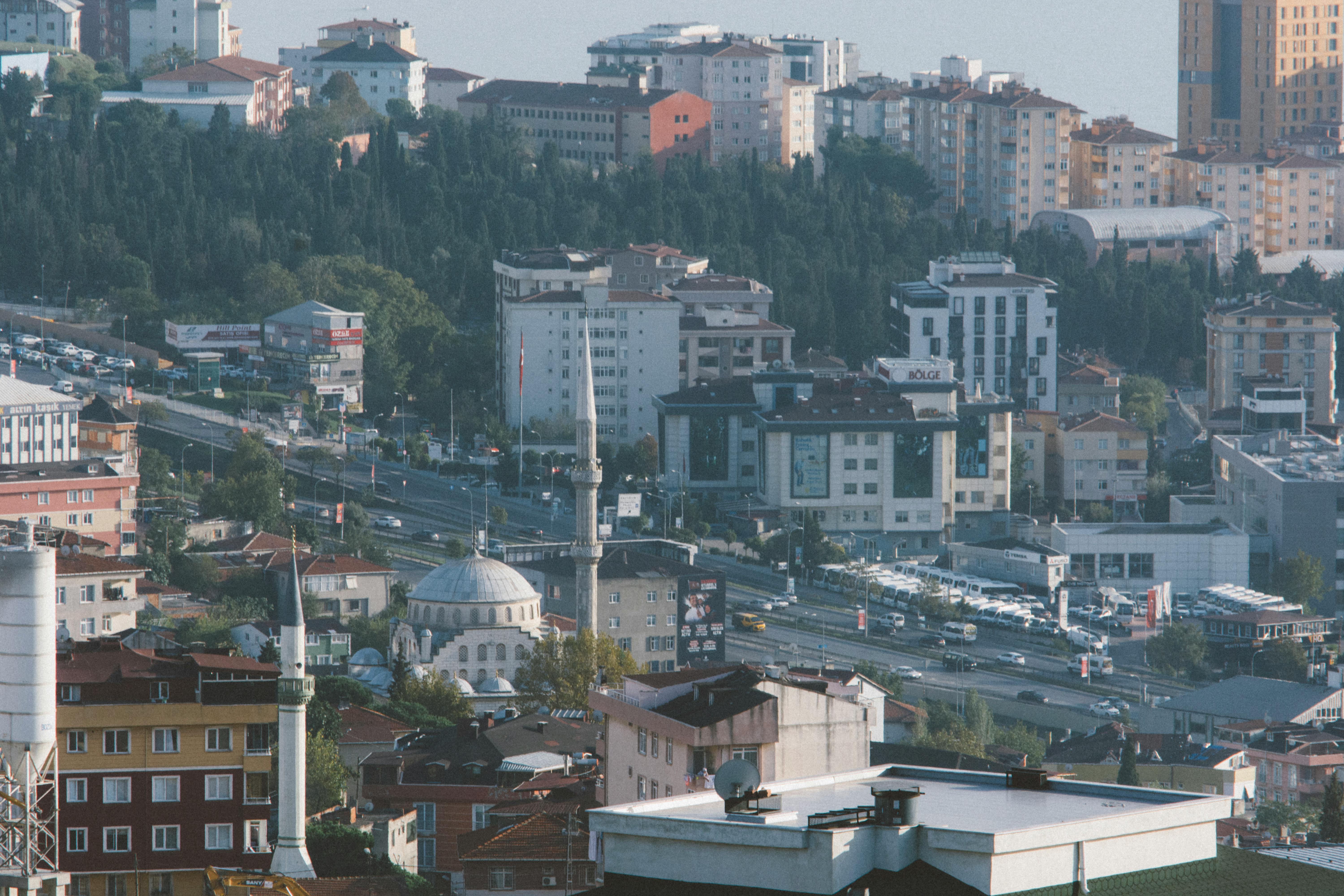 A scenic aerial view showcasing a vibrant cityscape, highlighting a mosque and urban architecture.