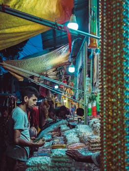 A vibrant night market with diverse stalls and shoppers engaging in evening activities.
