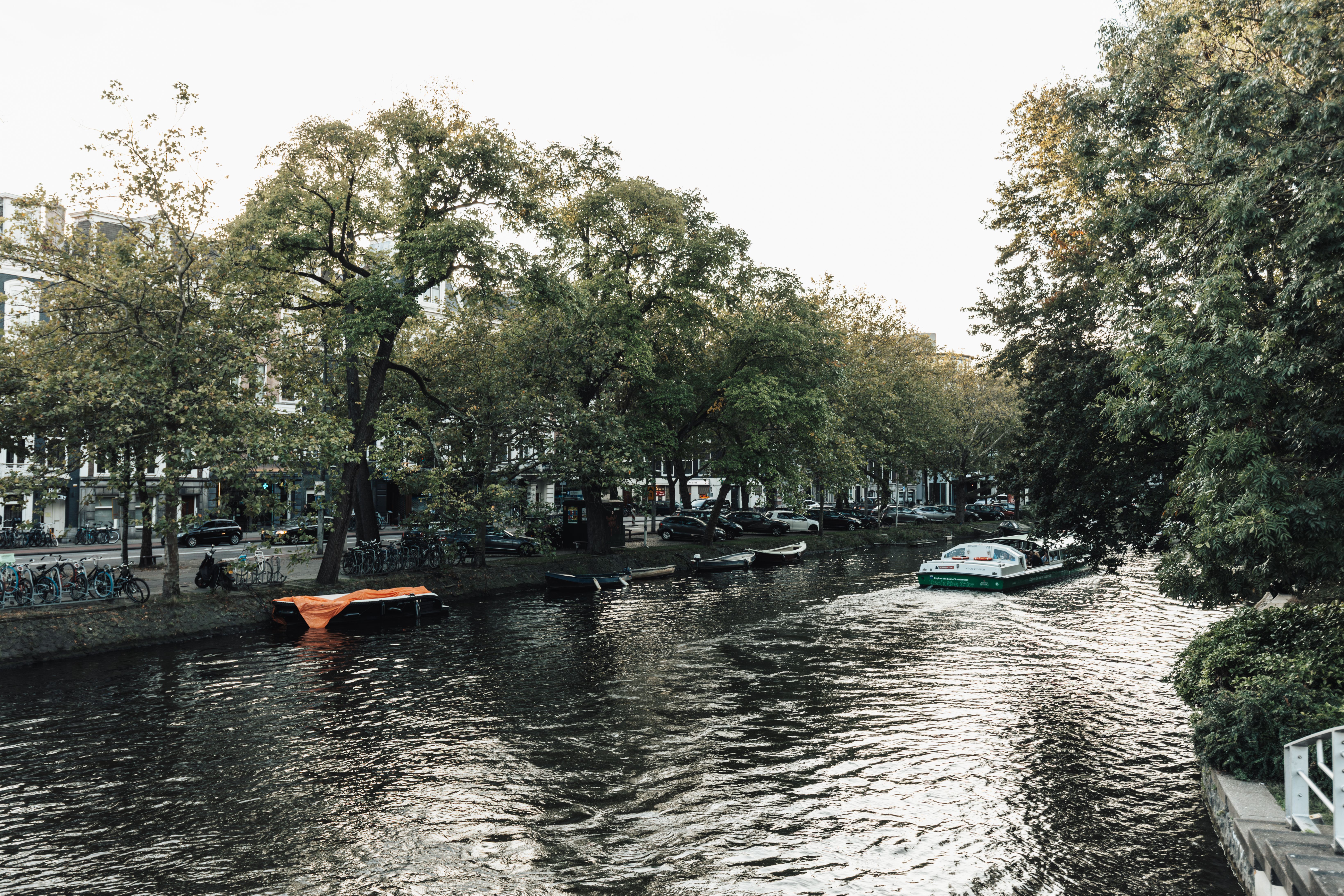 Tourists enjoying a canal boat ride in Amsterdam, Netherlands