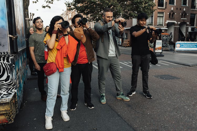 A Group Of People With Cameras