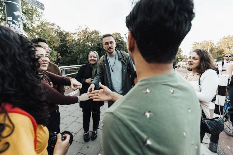 Group Of People Discussing On A Bridge