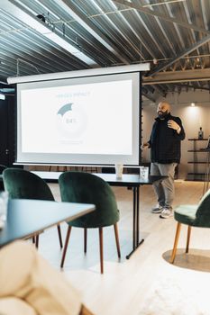 Professional business presentation taking place in a stylish modern office with a focus on impactful results.