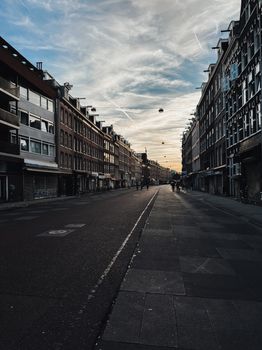 Captivating sunset over a residential street in Amsterdam, showcasing classic Dutch architecture.