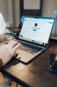 A focused shot of a person using a laptop indoors, highlighting device interaction.