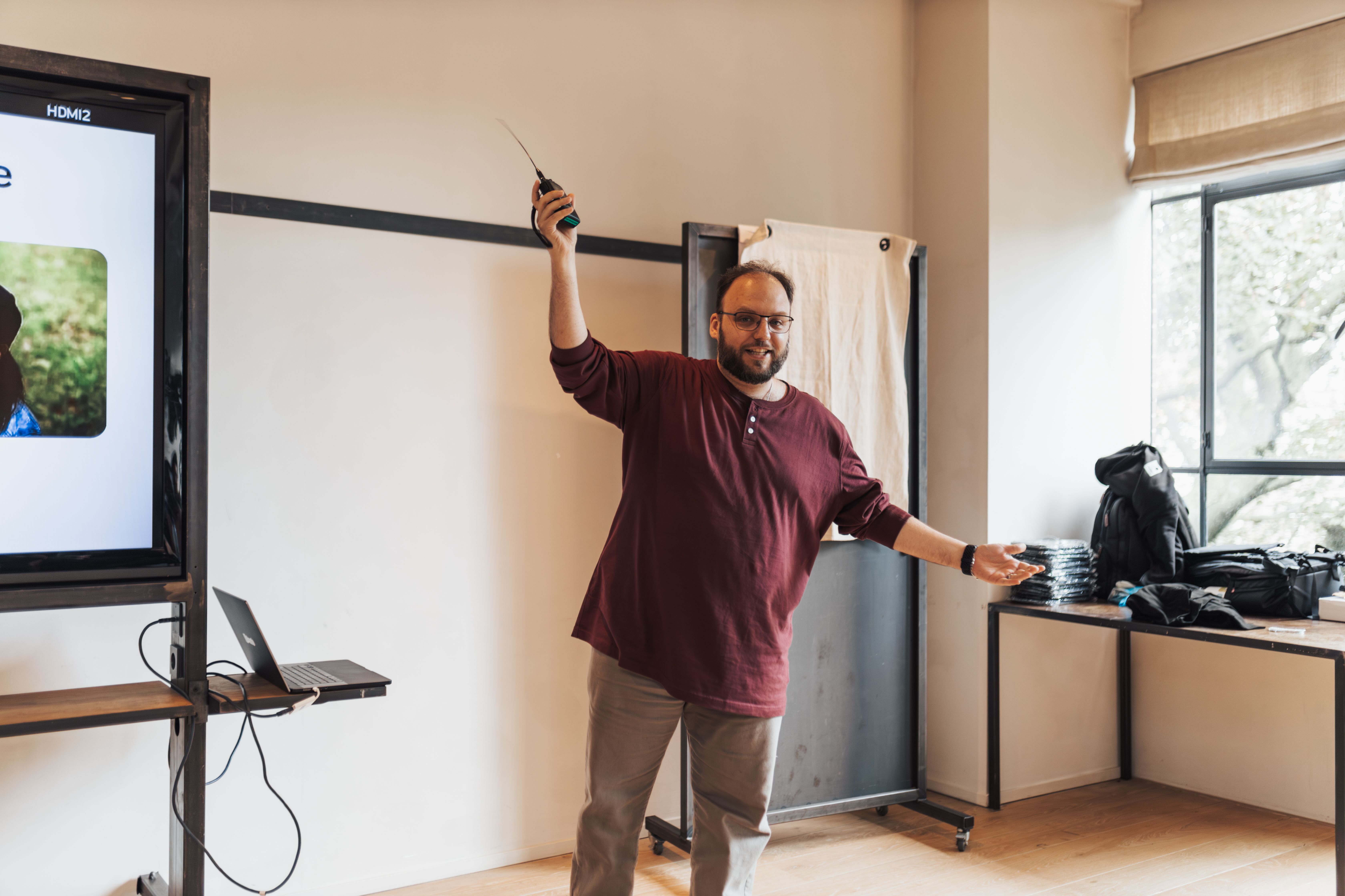 Man Presenting with Remote in Raised Arm · Free Stock Photo