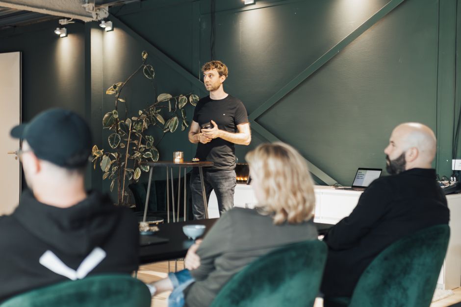 Business presentation in a modern office setting with a diverse group listening attentively.