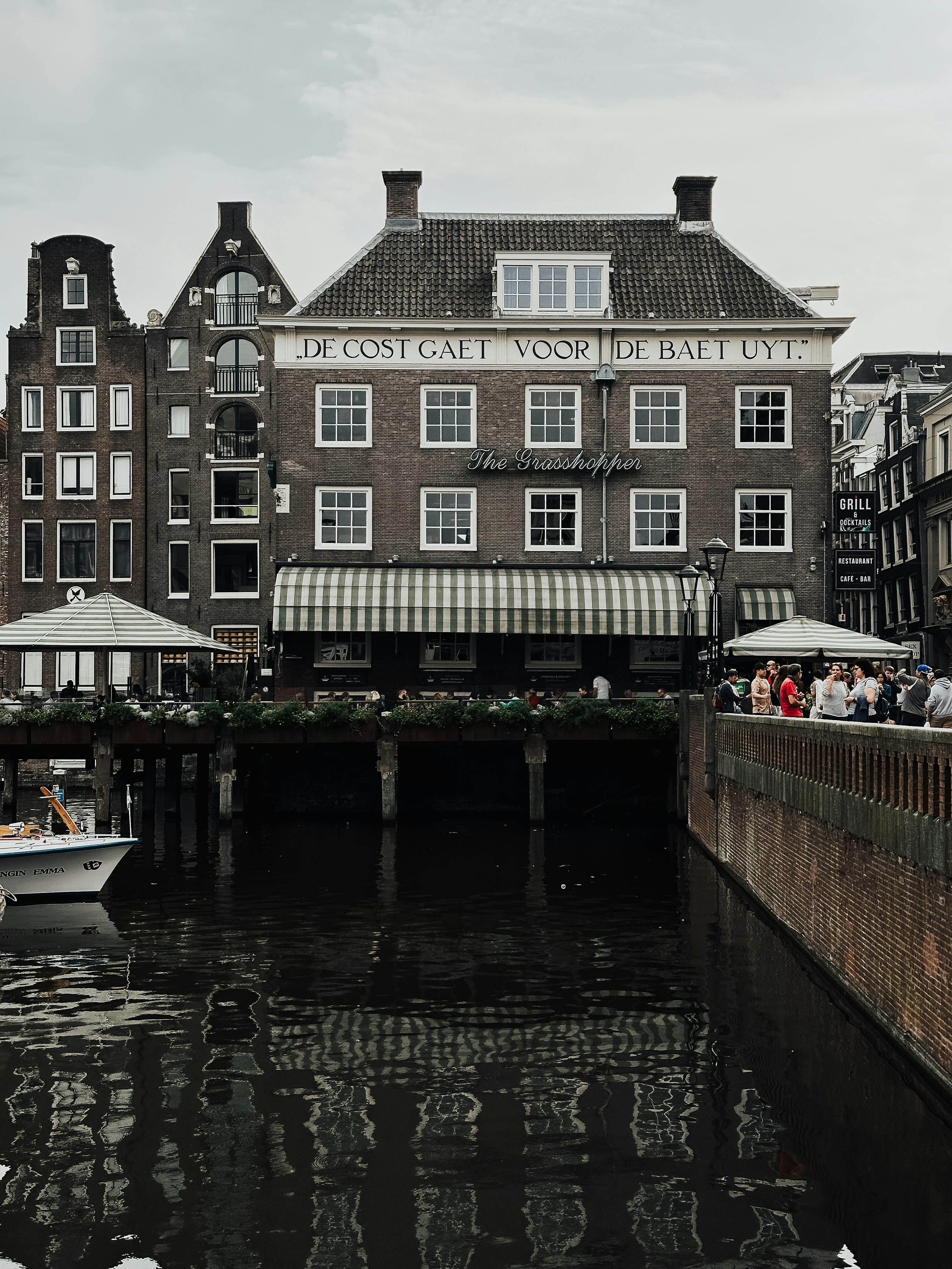 Explore the historic charm of Amsterdam's canals and traditional Dutch architecture with this captivating street scene.